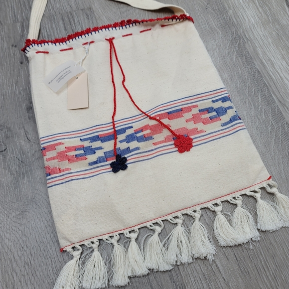 Boho fabric crossbody bag with knit string and flowers and fringe. 10"×9" - Picture 6 of 8